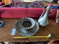 Photo showing the Turkish ewer and wash basin with tray alongside measuring tape indicating size.