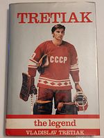Front cover of the book showing Vladislav Tretiak in full hockey gear and CCCP uniform standing with gloves and stick.