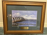 Framed print showing the full artwork 'Confederation Bridge' with wood frame and gold plaque.