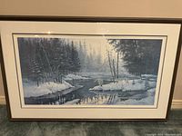 Front view of framed winter nature print with wolves, showing overall condition and size