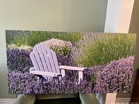 Full view of the large rectangular art print showing a white Adirondack chair in a field of lavender and greenery.