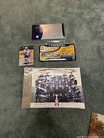 Overview photo showing all memorabilia items including two team photos, a player card, and a ticket.