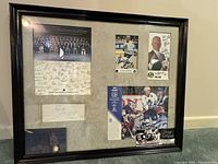 Framed collection of Toronto Maple Leafs memorabilia showing autographed photos and team roster sheet.