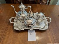 Full view of the complete Viking Plate silver tea and coffee set arranged neatly on the serving tray on a wooden table.