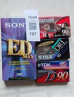 Lot of new blank media tapes including one Sony ED Max VHS tape and four blank audio cassette tapes from Maxell, Fuji, and TDK brands.