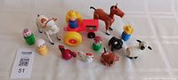 Photo showing entire Fisher-Price Fisher Farm People set including farmer figures, animals, and tractor on a white background