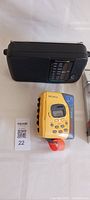 Yellow Sony Walkman and black Panasonic radio displayed on white surface