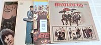 Four Beatles vinyl record covers arranged side by side showing the titles Rubber Soul, Yesterday and Today, Sgt Peppers, and Beatles '65.