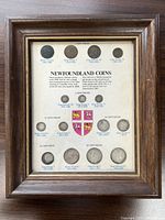 Front view of framed Newfoundland coin collection showing all mounted coins and printed backing.