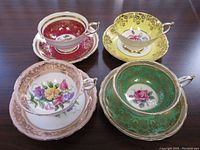 Overhead view of all four teacup and saucer sets showing cup and saucer patterns and colours