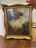 Original landscape oil painting with signature by Cesy, shown in ornate gold frame under glass.