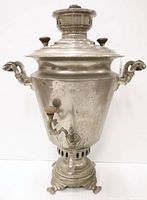 Full front view of silver-plated samovar showing body, handles, spout and base