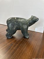 Side view of the soapstone polar bear sculpture showing full body and stone texture