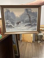 Full view of framed oil painting showing moose in snow-covered forest