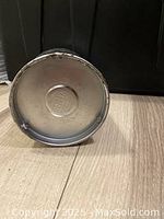 Bottom of the vintage thermos showing manufacturer markings embossed in metal.