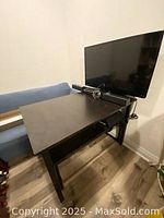 Side angle showing the rectangular deep brown dining table with TV in background.