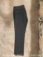 Gray trousers laid flat showing side profile and waistband.