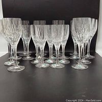 Set of 20 lead crystal glasses including 10 wine goblets and 10 champagne flutes shown against a black background.