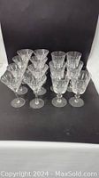 Full front view of the 8 martini glasses and 6 footed goblets arranged in rows.