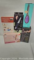 Full lot showing all boxed hair grooming tools and Pilates starter kit displayed together