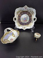 Lot of three Limoges porcelain miniatures consisting of a square plate, basket and trinket box, showing arrangement and detail