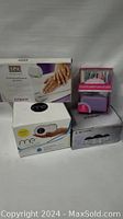 Full lot of four boxed personal care and manicure items.