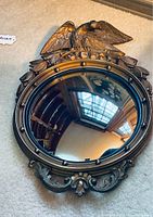 Front view of the antique convex bubble mirror with American eagle design and convex bubble reflective glass.