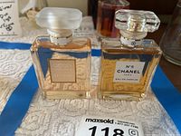 Both Chanel perfume bottles side by side on blue tape-lined surface, showing front labels and contents level.
