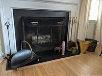 Wide-angle view of fireplace hearth showing all accessories