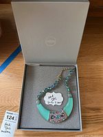 Heidi Daus necklace in open gray HSN box with foam insert and handwritten box size label 8x9x2.
