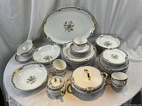 Full assortment of dinnerware displayed on white backdrop, includes all plates, bowls, cups, and serving pieces
