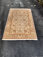 Full view of rug laid out on pavement