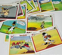 Close-up of several baseball cards featuring Yosemite Sam with a gun and other characters in cartoon baseball scenes