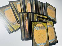 Image showing backs of the Magic the Gathering cards, standard card backs with brown background and Magic the Gathering logo.