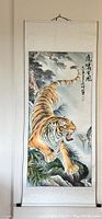 Full front view of scroll painting showing tiger descending a mountain.