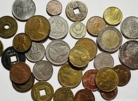 Various international coins arranged to show diversity of shapes, metals and designs
