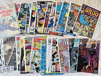 Overview of 25 various comic books with colorful illustrated covers featuring superheroes and fantasy themes.