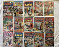 Top view of all 15 vintage Archie comic books laid out showing cover art and titles.