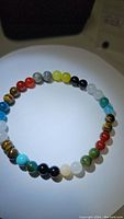 Front view of the multi-colored natural gemstone bracelet with alternating stone beads.