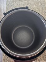 Close-up image of the non-stick inner pot of the Farberware pressure cooker, showing the cooking surface.