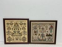 Photo of two framed embroidery samples side by side against a white wall.