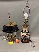 Photo showing both lamps side by side, including a small apple for size reference.