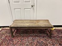 Front view of the vintage rustic teak wood outdoor bench showing full length and slatted seat design.