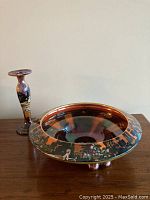 Overall view of footed fruit bowl and baluster candlestick holder on table