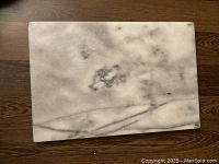 Top view showing white and grey veining marble surface in rectangular shape with smooth edges.