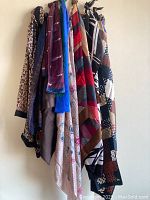 Group of scarves hung showing various patterns and colours