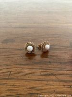 Front view of pair showing coiled wire basket design and central pearls