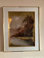Framed impressionist landscape painting depicting mountain, forest and water, painted on brass with linen mat and brass frame.