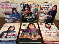 Six Ina Garten Barefoot Contessa cookbooks arranged in two rows showing covers and spines, titles visible