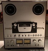 Front view showing full unit with empty reel spindles and control panel